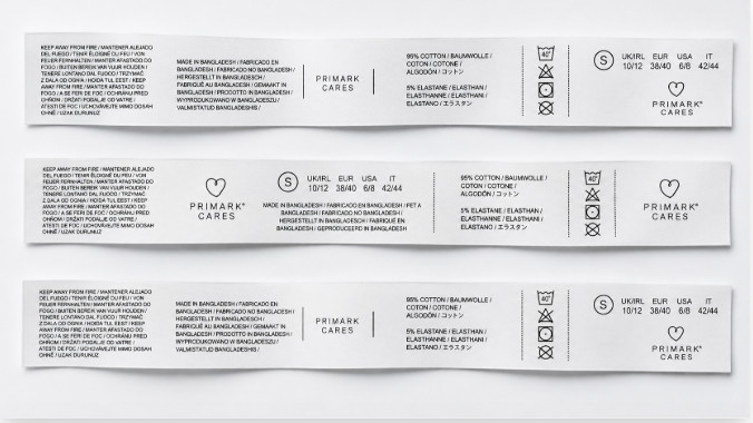 Printed care labels with multilingual care text, fibre composition and wash symbols