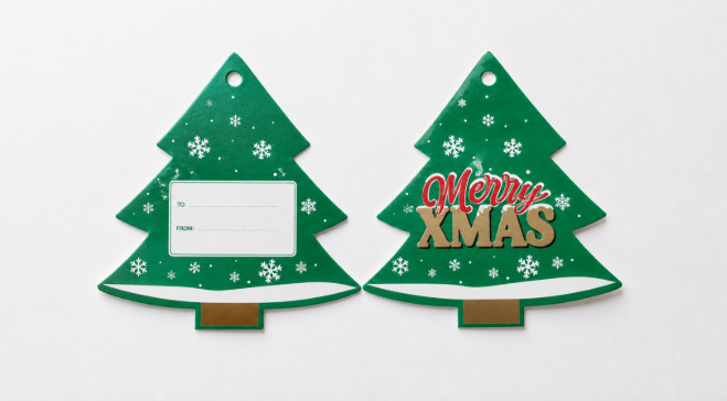 Two Christmas tree shaped die-cut hang tags, one reading Merry Xmas